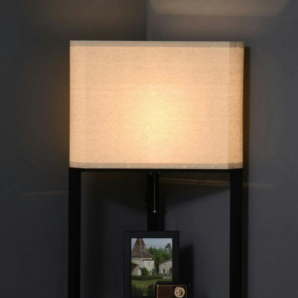 Tall corner floor lamp with black frame, beige fabric shade, and open storage shelves