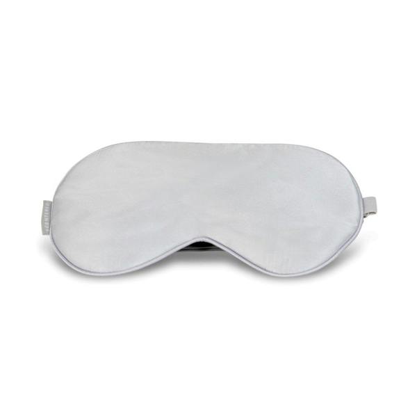 A white silk eye mask with an adjustable strap, designed to cover the eyes and provide light blockage for sleep.