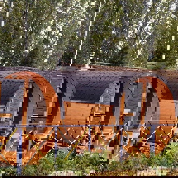 Barrel-shaped cabins near water