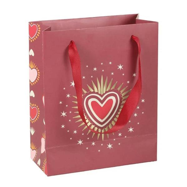 Maroon gift bag with red ribbon handles, sacred heart center design, starry sparkles