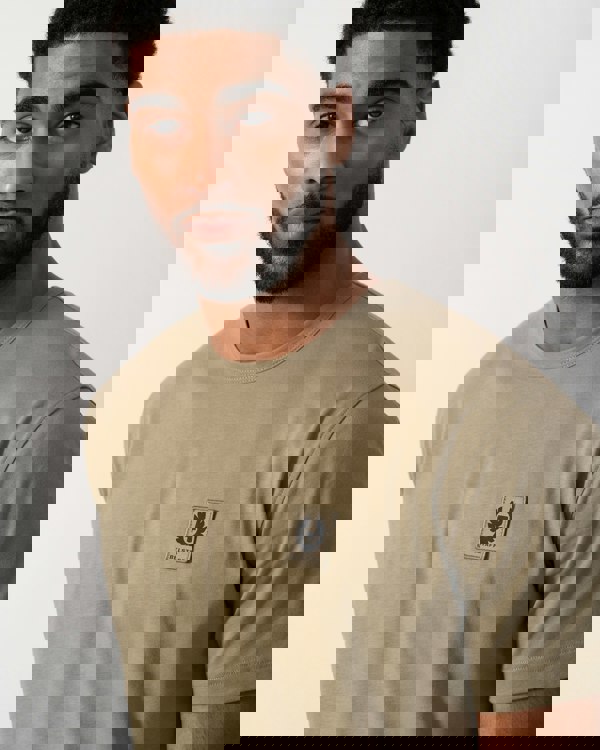Close up shot of a Model wearing a Belstaff Short Sleeved Mens Logo Patch T-Shirt in Fatigue Green