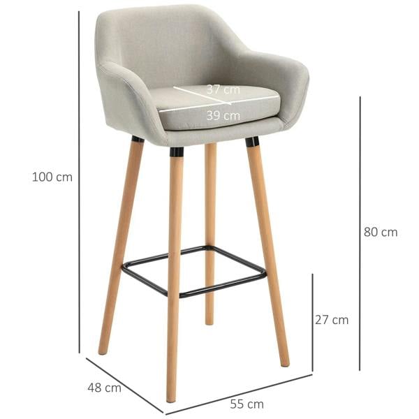 Beige upholstered bar stool with curved back and seat, light wood legs, and black metal footrest