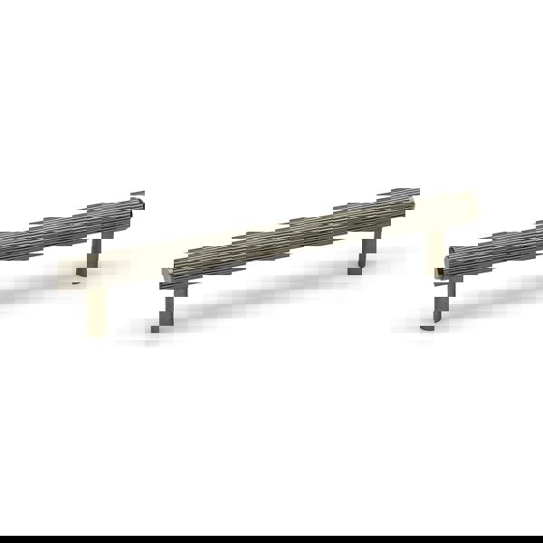 An antique brass reeded T-bar handle