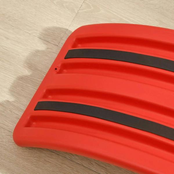 Red wobble board underside with black anti-slip strips on the base