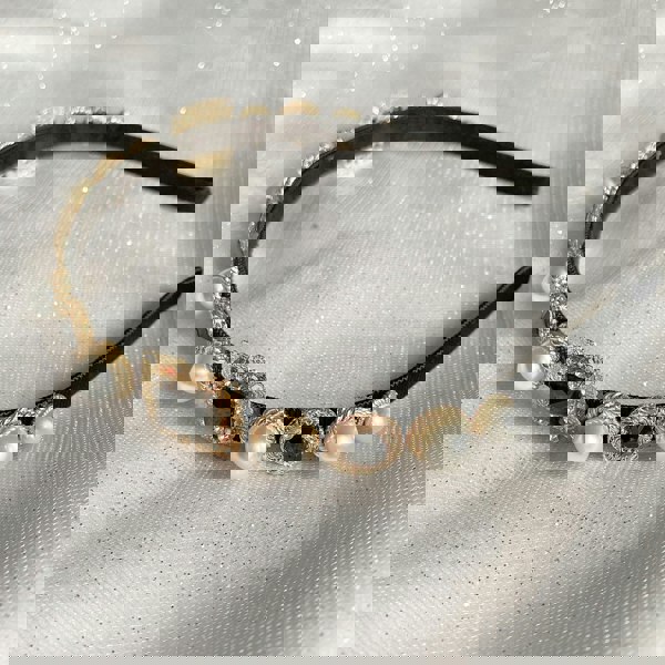 black headband with pearls in gold alice band