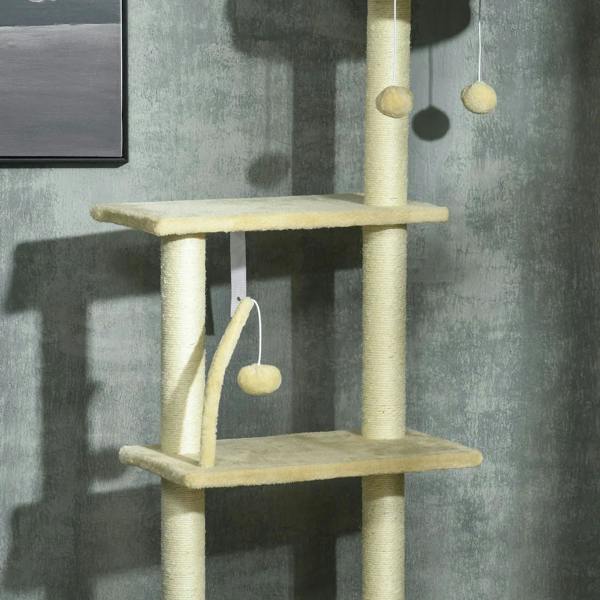 Beige cat tree tower with two platforms and hanging ball toys near the scratching post