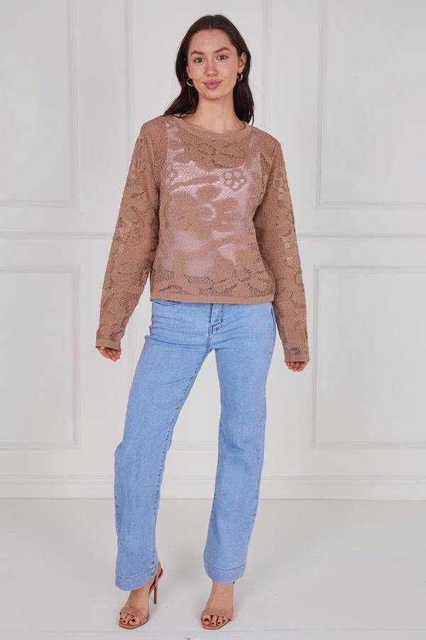 Model wearing a long sleeve crochet top with an open-knit pattern, styled with high-waisted jeans, featuring a relaxed fit and lightweight texture for casual everyday wear.
