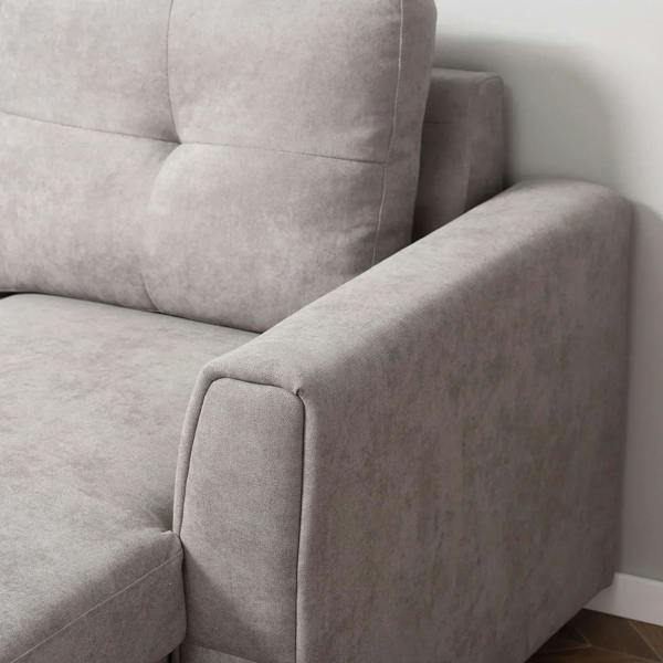 Light grey sofa bed chaise with rounded arm and smooth side panel