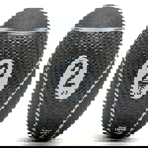 Black Reebok medicine ball with '2 KG' marking on a white background