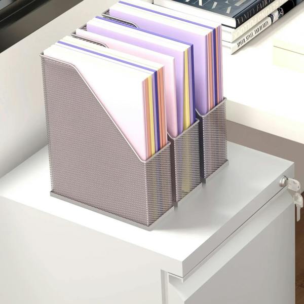 Metal mesh file insert organizer holding stacked folders and binders on a tabletop