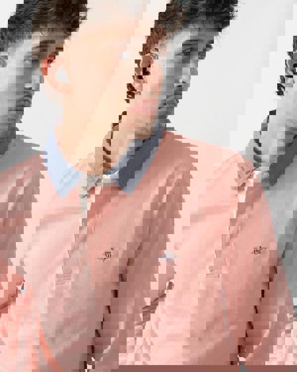 close up shot of a model wearing a GANT Mens Regular Fit Chambray Heavy Rugger in Bubblegum Pink