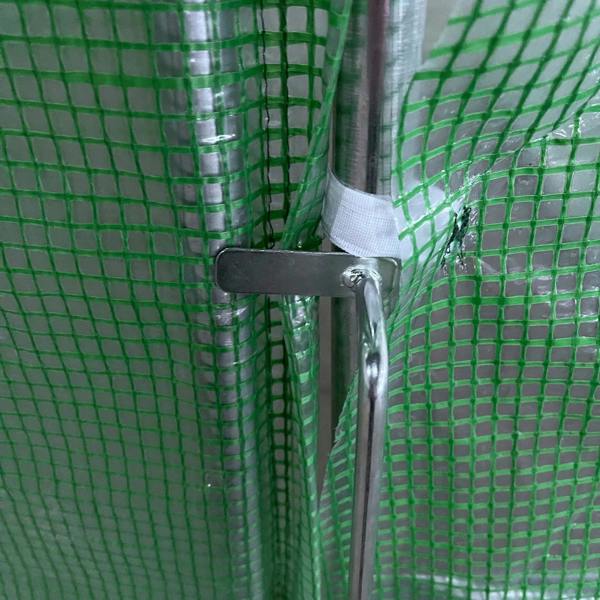 Green PE greenhouse mesh tied to galvanized frame tube with strap and clamp