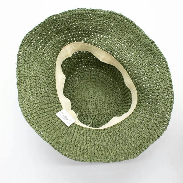 Moss green floppy straw sun hat underside with beige inner trim and tag