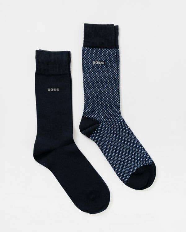 Two BOSS crew socks on a light gray background: one solid dark navy sock and one blue sock with a fine white geometric pattern.