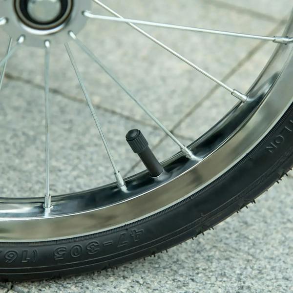 Close-up of stroller wheel with black tire tread on a three-wheel pet buggy
