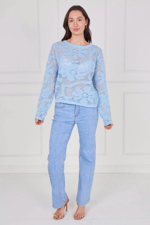 Model wearing a long sleeve crochet top with an open-knit pattern, styled with high-waisted jeans, featuring a relaxed fit and lightweight texture for casual everyday wear.