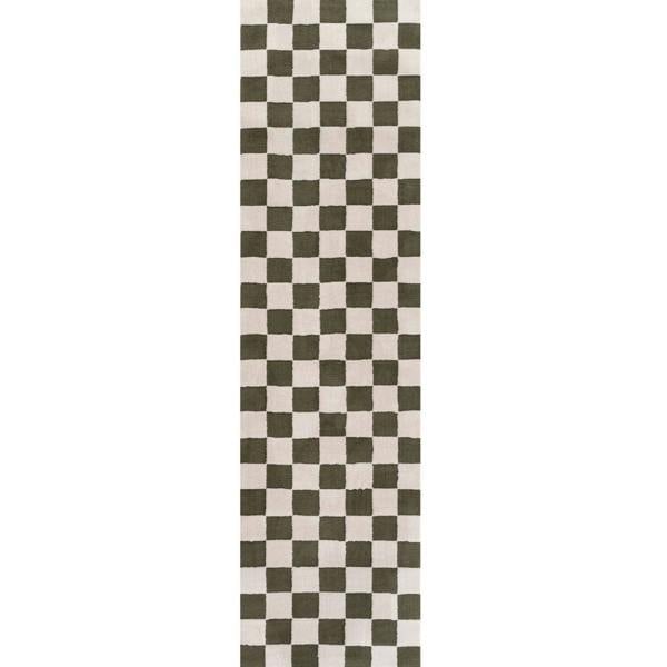 Checkered patterned rug with green and white squares on a plain background
