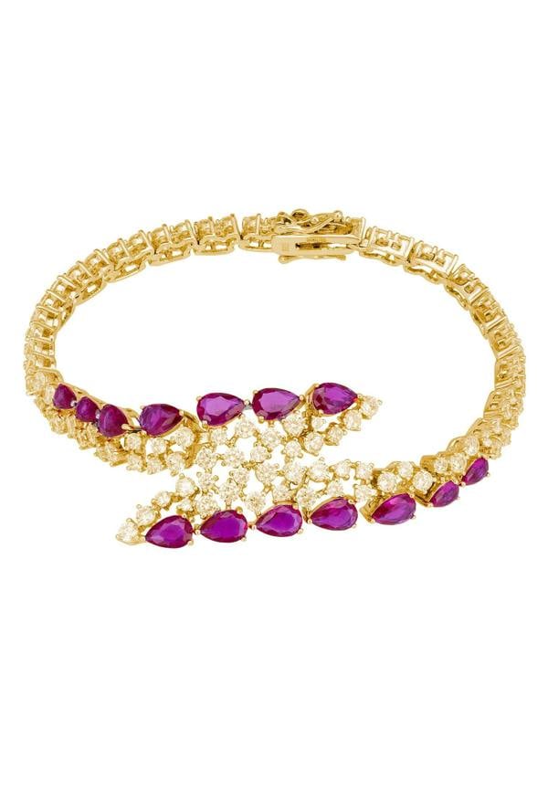 18k gold plated tennis bracelet with a central motif containing teardrop rubies and simulated diamonds.