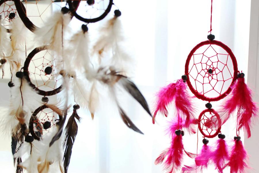 Large round dreamcatcher with pink-and-purple feather fringe and black web center