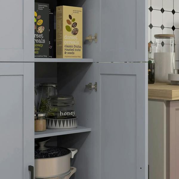 Grey kitchen cupboard interior with an open shelf holding jars and boxed pantry items