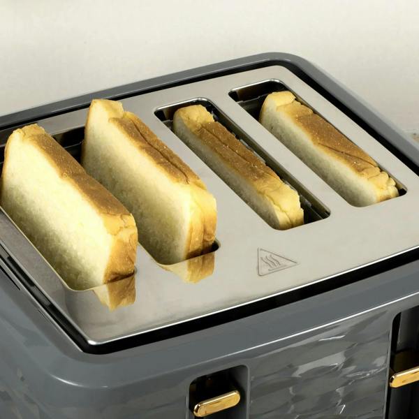 Grey four-slice toaster with four toast rolls in the slots, close-up
