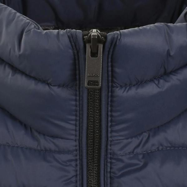 Close-up of a navy BOSS Oden 2 puffer jacket featuring a quilted design and branded black zipper pull.