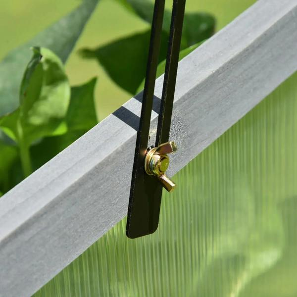 Grey cold frame latch with gold-toned screw on clear polycarbonate top edge