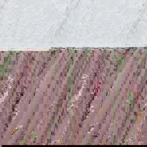 Pink floral embroidery on a textured fabric background