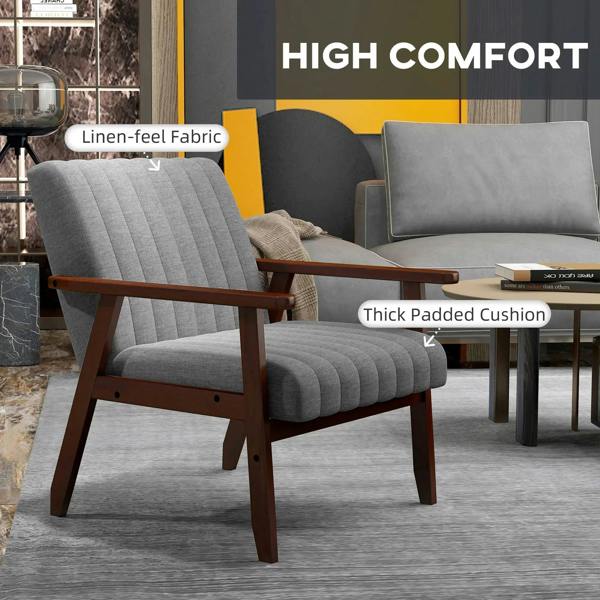 Grey tufted accent chair with thick padded seat and wooden armrests