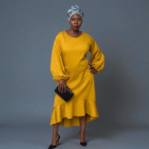 Women's Plus Size Gold Aphrodite Leopard Jacquard Dress styled with a black clutch and black heels for an elegant lookWomen's Gold Aphrodite Leopard Jacquard Dress shown from the back. Plain Background.