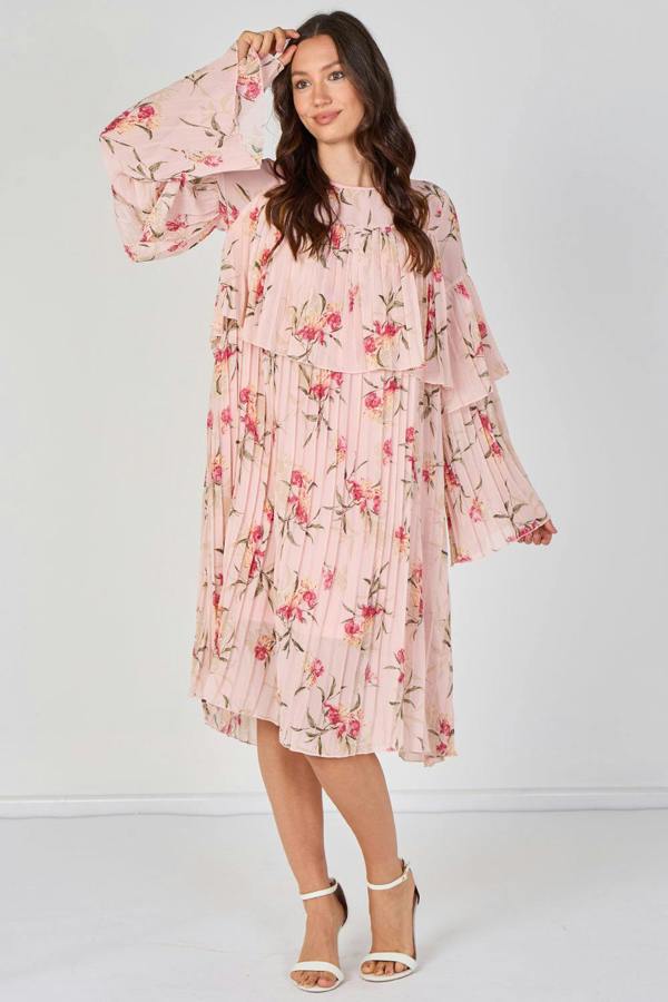 Woman wearing a pink floral dress on a white background