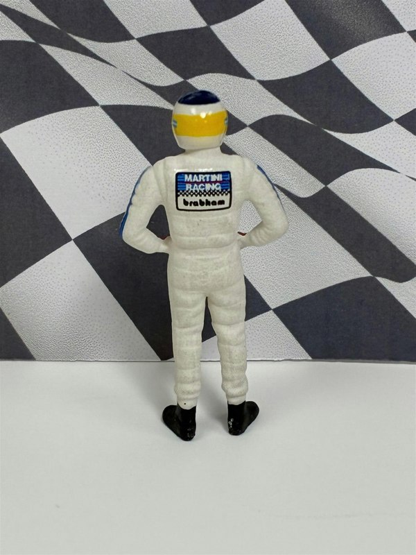 a toy figure of a man in a race suit