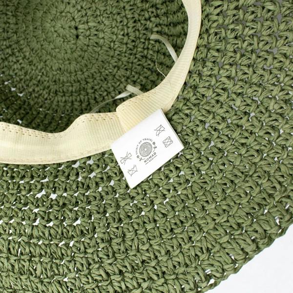 Close-up of moss green hat band with beige inner edging and brand tag