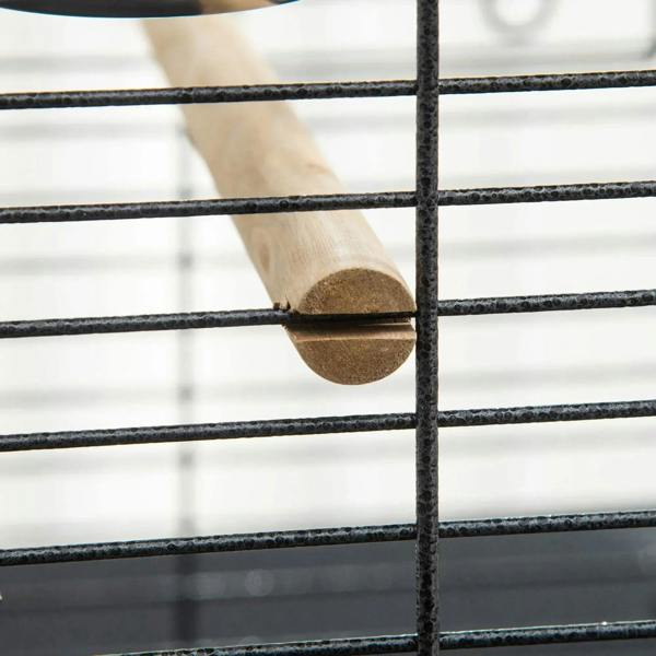 Wooden perch secured inside dark grey bird cage between metal bars