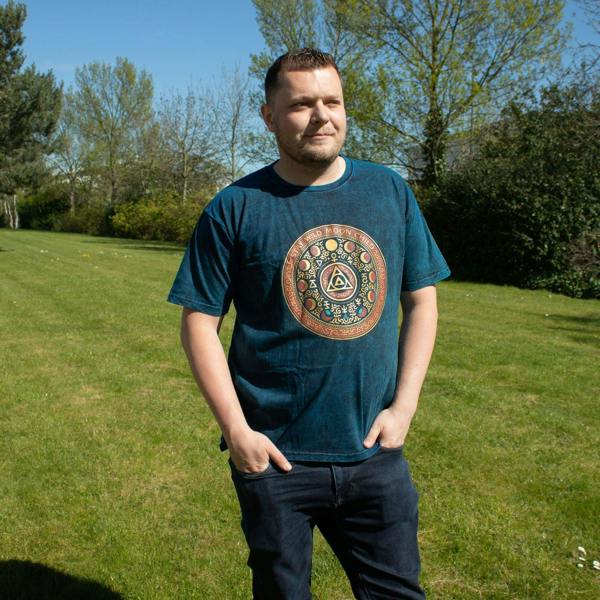 Blue stonewashed cotton T-shirt worn by a person, featuring circular Stay Wild Moon Child graphic