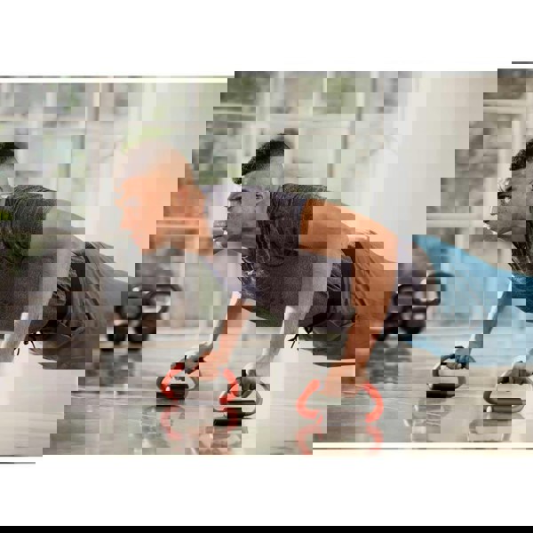 Man doing push ups in the gym using Reebok Push Up Bars