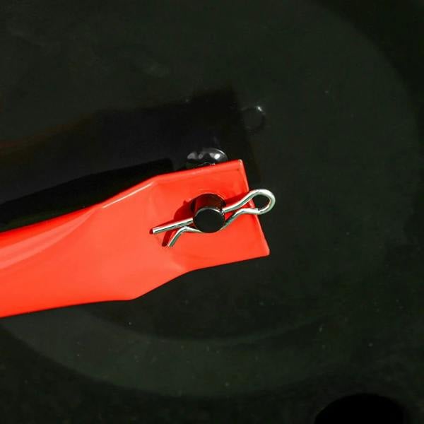 Red lawn roller fill opening with removable drain plug and black cap on drum