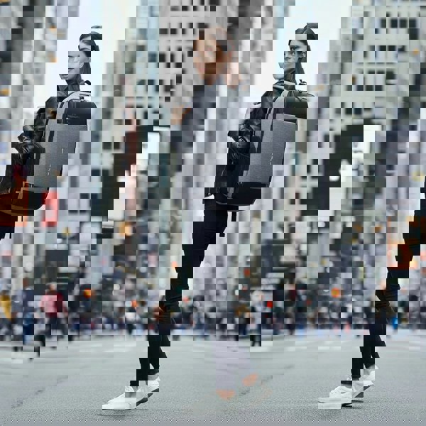 Woman with a backpack walking on a city street best travel laptop backpack multi-functional