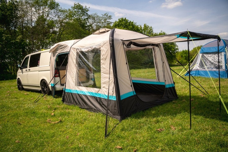The OLPRO Snug Inflatable campervan Awning attached to the tailgate of a Volkswagen T5 camper, the doors of the awning are open & the canopy is up