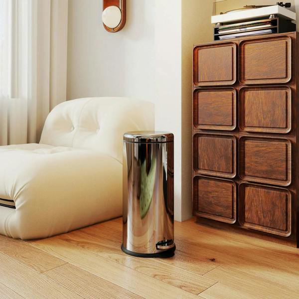 Polished silver stainless steel waste bin with black foot pedal and round lid