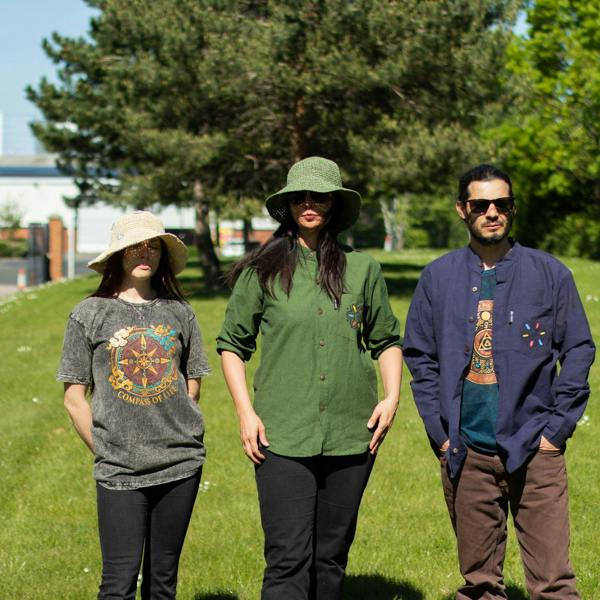 Group outdoors wearing graphic t-shirts; blue circular design visible on one shirt