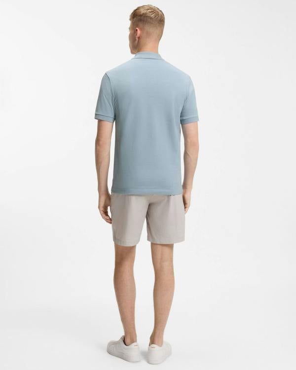 Model wearing BOSS Orange Passenger Mens Stretch-Cotton Slim-Fit Polo Shirt with Logo Patch in Light/Pastel Blue 458 - Back