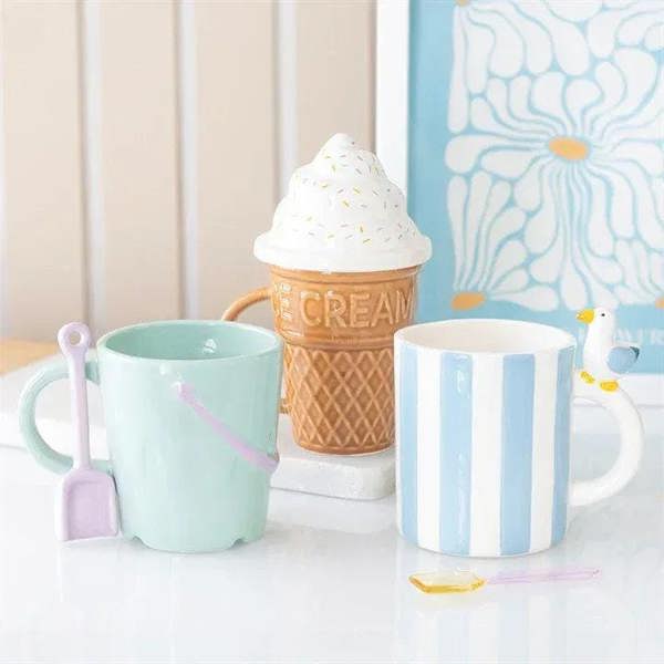 Mint pastel bucket mug with pink spade spoon on display