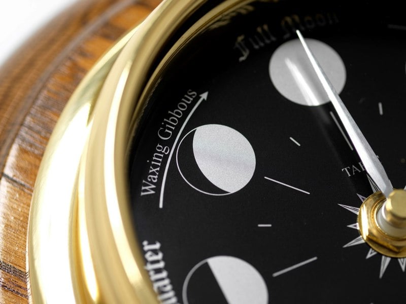 Prestige Brass Moon Phase Clock With a Jet Black Dial Mounted on a Solid English Dark Oak Wall Mount - TABIC CLOCKS