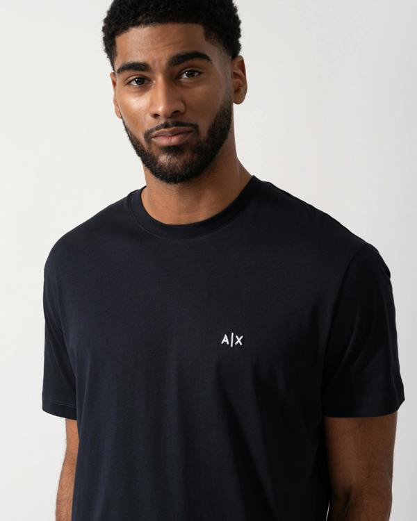 detail shot of a model wearing an Armani Exchange Mens A|X Monogram T-Shirt in Deep Navy