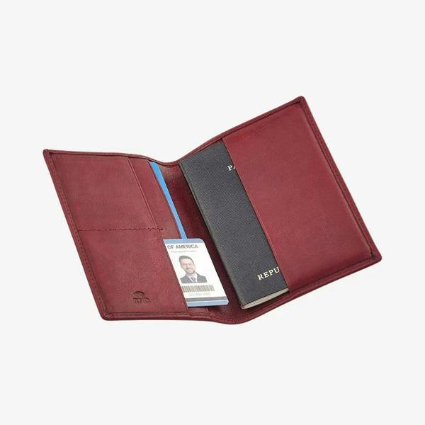 Bordeaux leather passport holder with a passport and card holder on a white background
