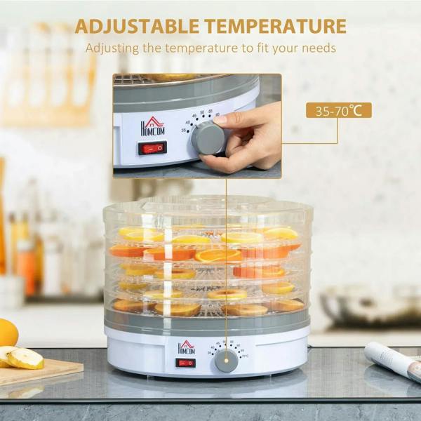 5-tray food dehydrator with clear lid and adjustable temperature knob, fruit slices inside