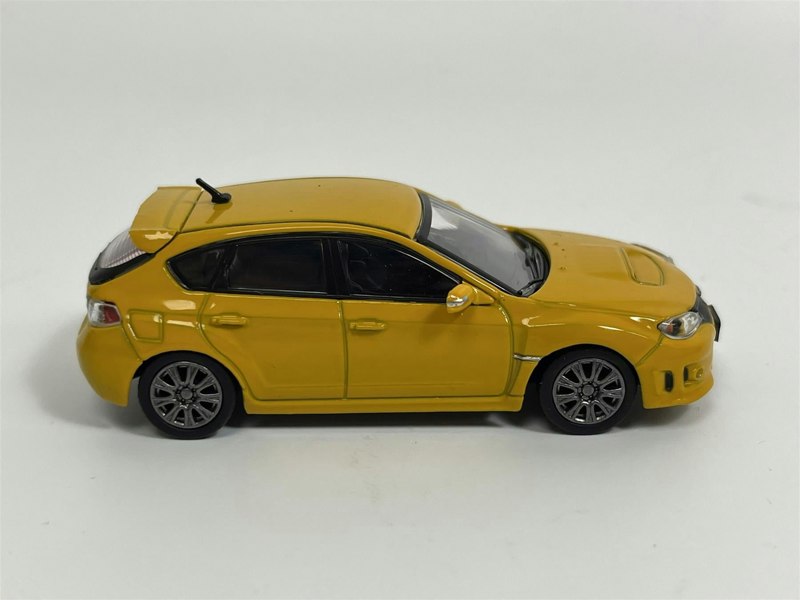a yellow toy car on a white background