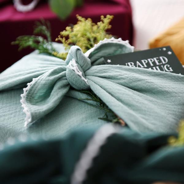 Reusable Burgundy Lace Trimmed Fabric Gift Wrap - lifestyle shot