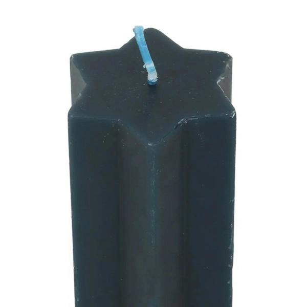 Star-topped navy taper candle with blue wick close-up